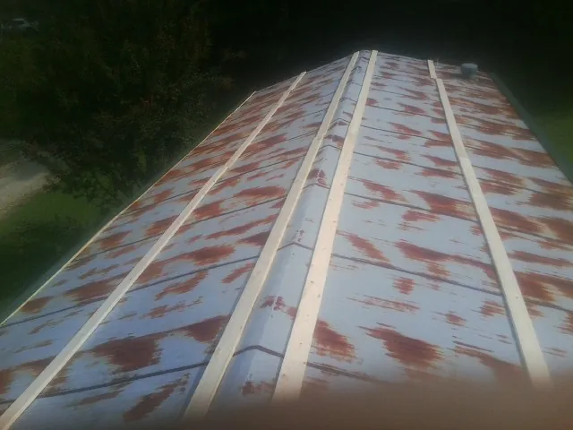 Rusted metal roof panels with new wood purlins before replacement — Storm Damage Roof Repair in Swedesboro by Roofing Brothers