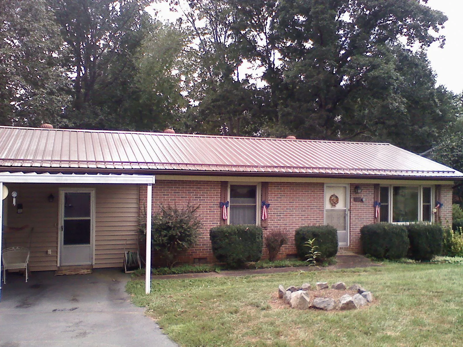Bronze metal roof and carport on a brick ranch home — Roof Repair work by our crew in Swedesboro
